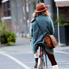 Photo of bicyclist with messenger bag and cross body strap.