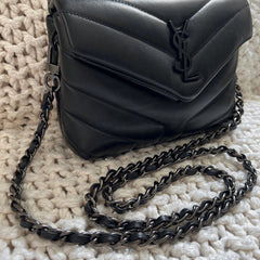 Photo of YSL purse with gunmetal black chain and black leather woven through.