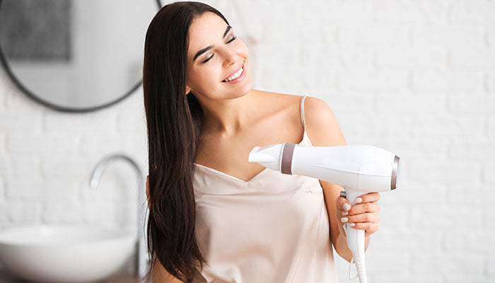 blow drying her hair