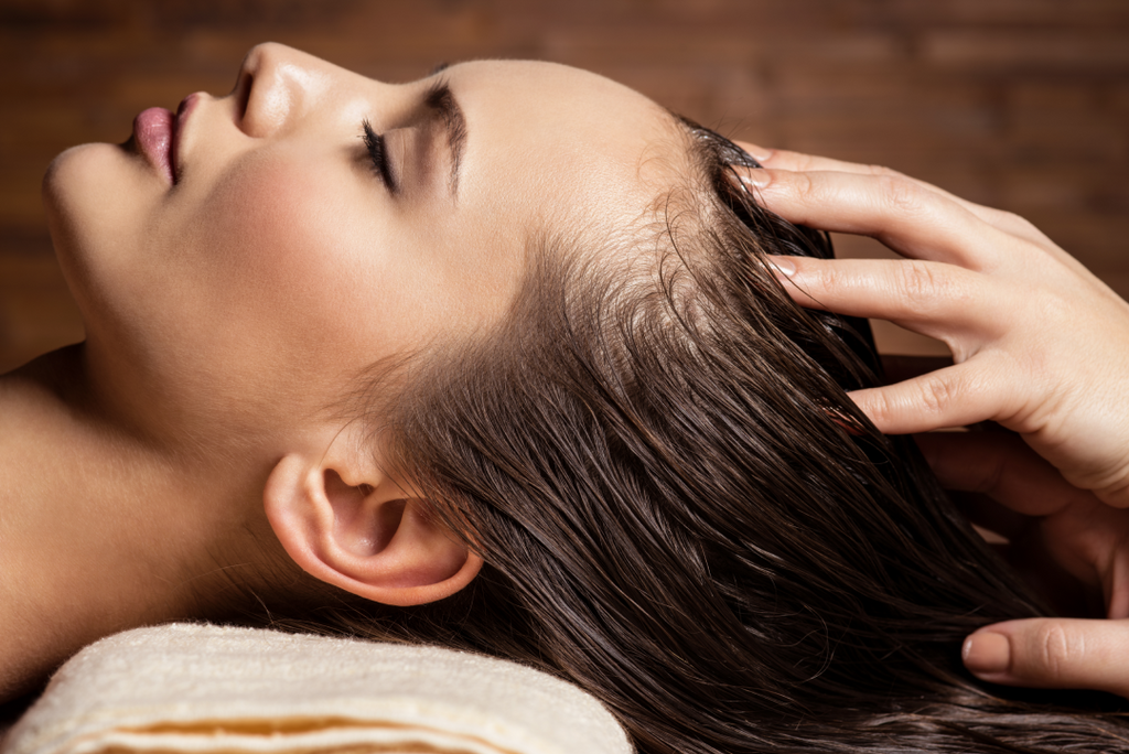 Massaging a women's scalp