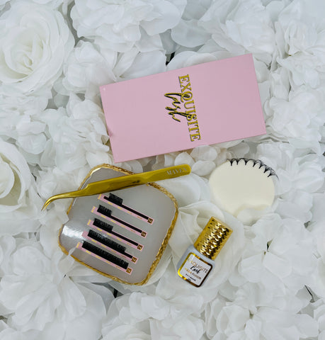 lash tray, lash glue & Tweezers  laying on a bed of white roses