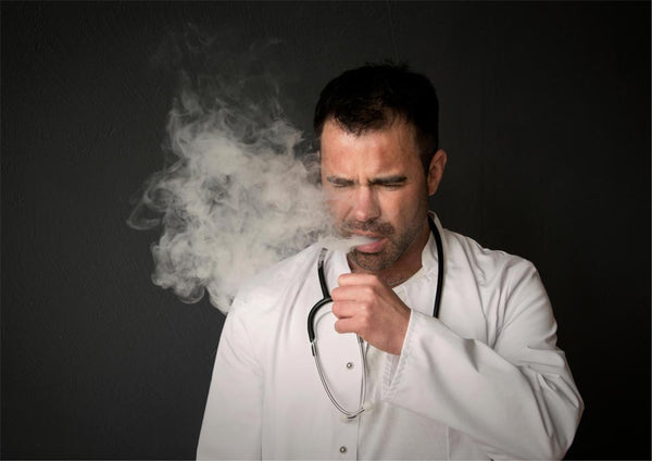 Man with stethoscope coughing. Don't vape on burnt vapour coils.