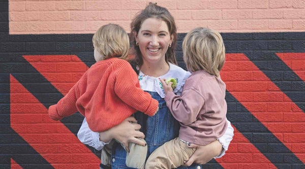 Emma Campani - Sleep Expert - Holding her Two Boys with their face away from the camera