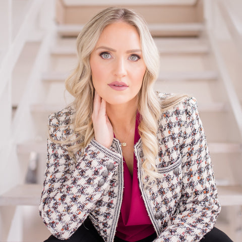 Brandi Gregge sitting at the bottom of a staircase.