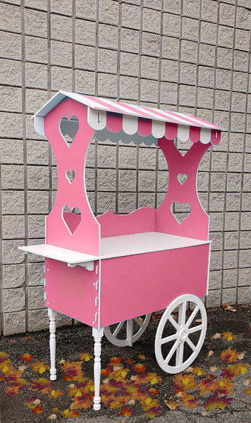 Barbie and Ken cart, nostalgic candy cart, stylish sweet cart, event display cart, portable party cart, collapsible event cart, easy-to-assemble candy cart, durable party cart, washable sweet cart, stain-resistant candy cart, rust-resistant dessert cart, 20 kg capacity cart, 22 inch wide cart, 28 inch long cart, 70 inch high cart, outdoor suitable cart, indoor appropriate cart, trendy event cart, customizable theme cart, affordable candy cart, practical sweet cart