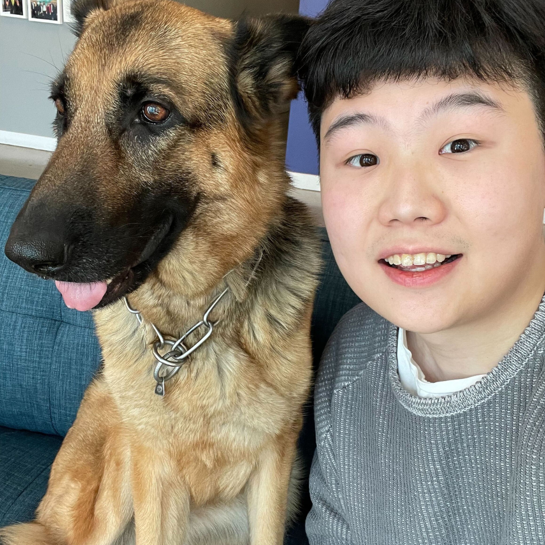 zach, co-founder of Charmy with a German Shepherd dog