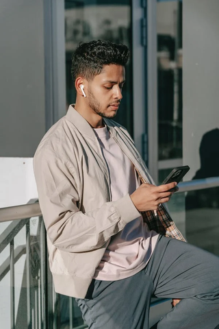 A guy using ANC Earbuds for music