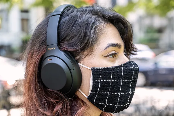 A girl with a Sony WH-1000XM4 wearing a mask, courtesy of Theverge