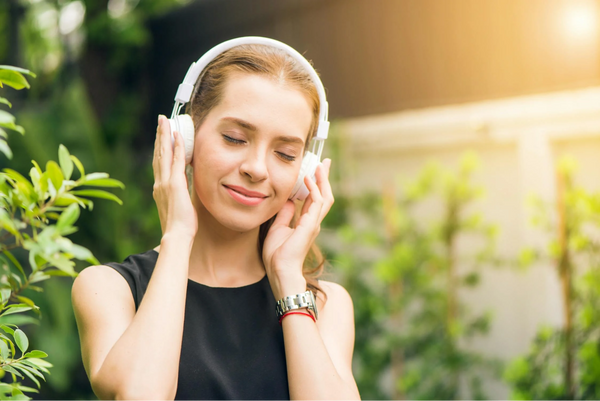 Image of a lady enjoying music using ANC Headphones