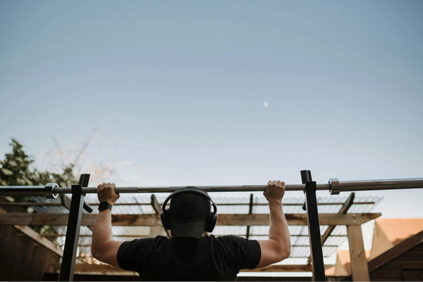 A guy using ANC Headphones during a workout