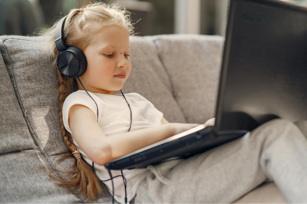 A Kid Studying Online Using Kids Headphones