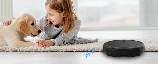 A kid near a pet and Robot vacuum-cleaning the floor