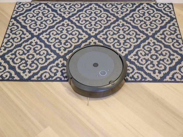 Robotic vacuum mopping a carpet