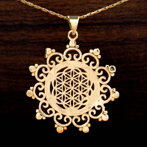 A pendant featuring a seed of life design on a wooden background