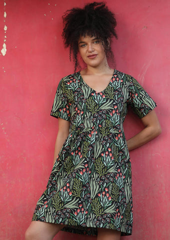 A model wearing a karma east dress above the knees