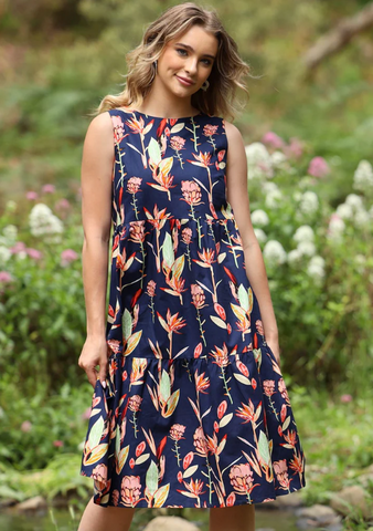 A woman wearing a karma east dress featuring a floral design