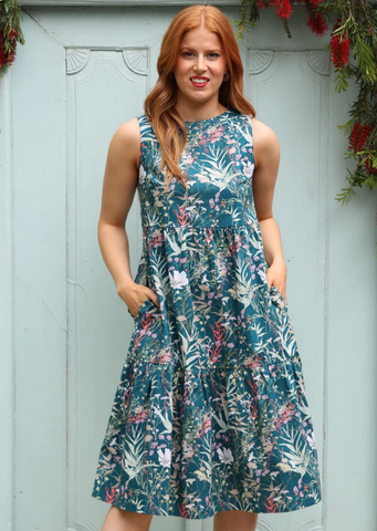 Model wearing a Karma east dress above the knees featuring floral motifs