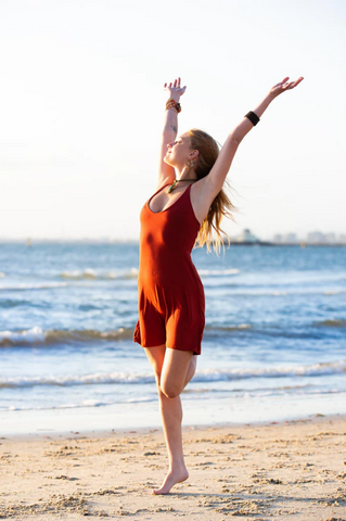 A girl wearing a red short dress at the beach