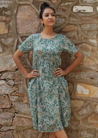 Model wearing a karma east dress featuring a flower printed design