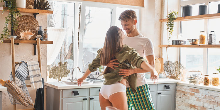 young couple being playful and sexy in the kitchen