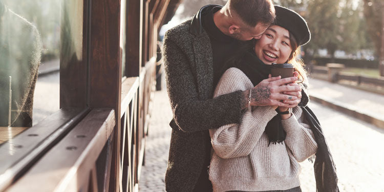 a young couple hugging on the street during autumn