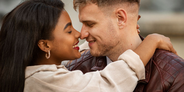 interracial couple hugging and lovingly looking at each other