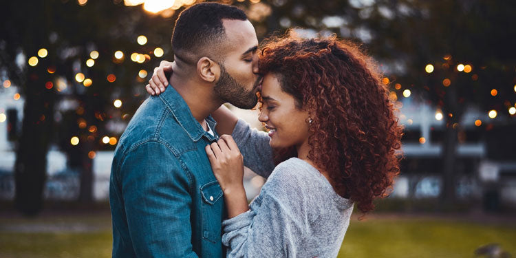 couple hugging and being loving in a park