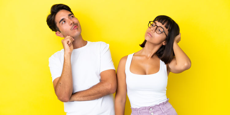 a man and woman both look up with questioning looks on their faces