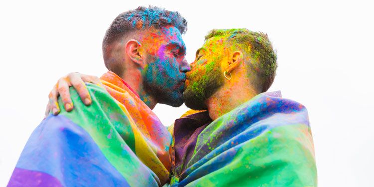  two men in rainbow flags kissing