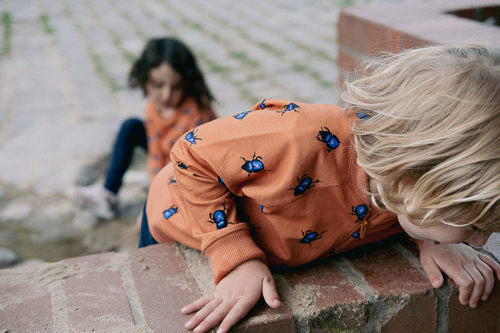 Boy dressed in the zip-up cardigan from thesnellaproject