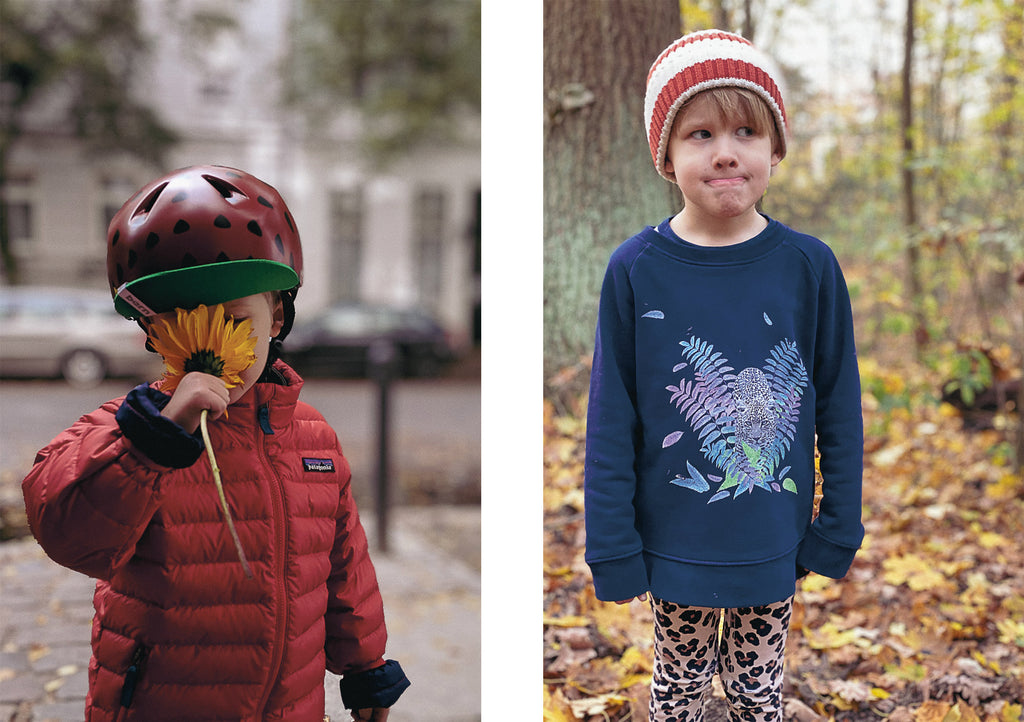 Boy smelling a sunflower and sating in the woods