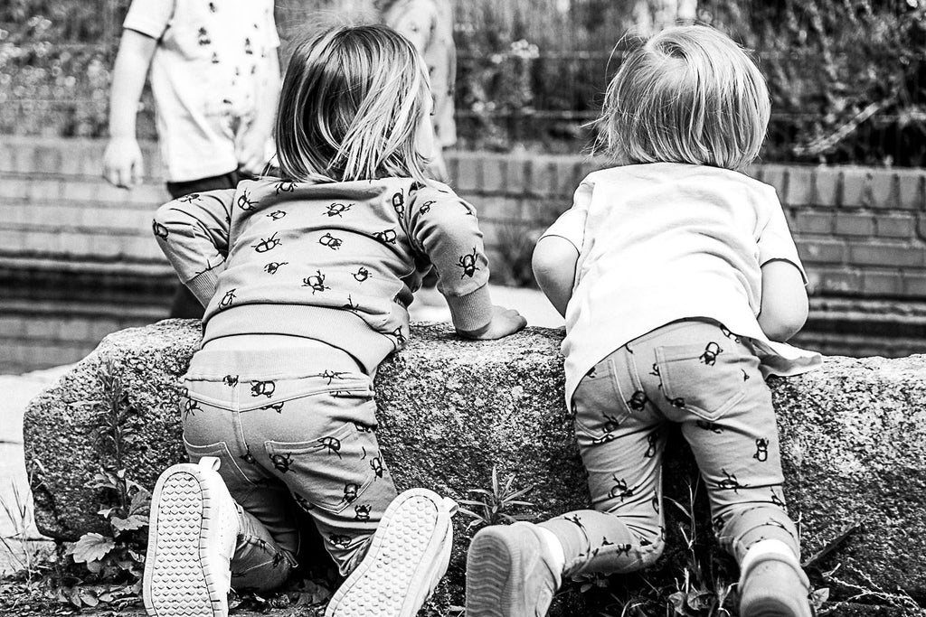 What are treggings? Children sitting on their knees playing and wearing treggings