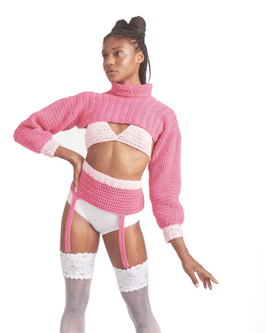 Model in pink and white outfit in front of white background