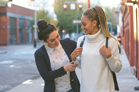 Two women on the sidewalk 