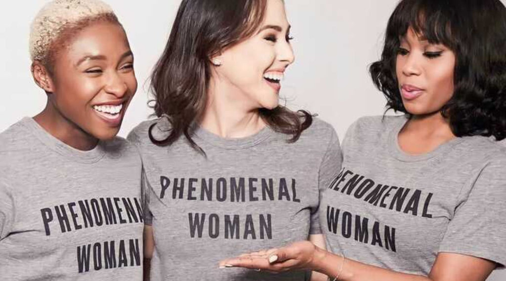 Three models wearing gray Phenomenal Women shirts