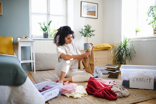 Woman donating old clothes