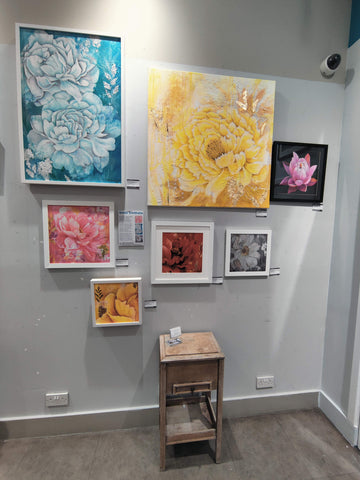 a selection of floral paintings by london artist smita sonthalia on display in ealing broadway