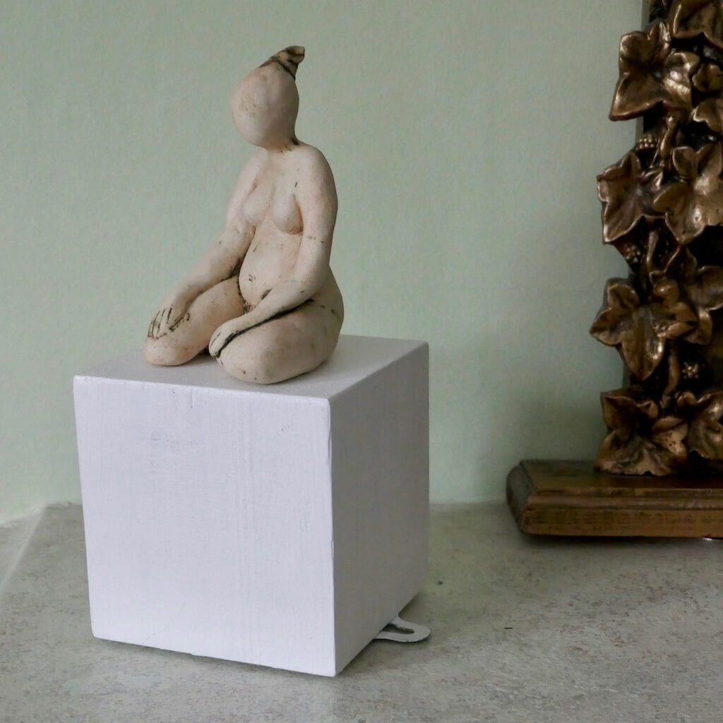 Figurine on a white cube ceramic art by Ruty Benjamini