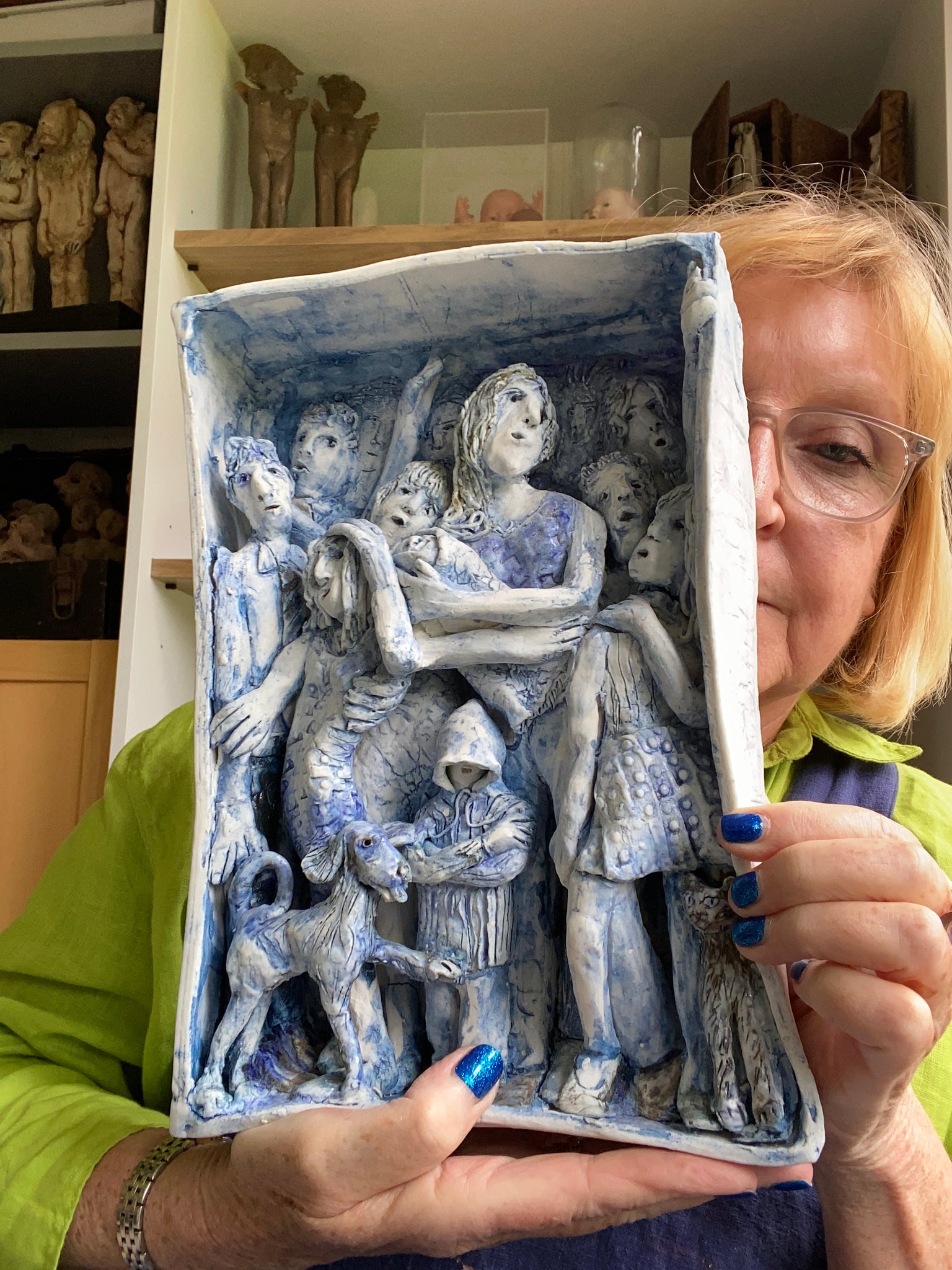 moving forward, an original ceramic tableau of figures moving towards the viewer by skylark artist heather tobias