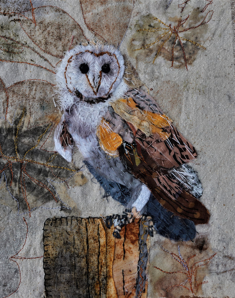 On the Lookout, by artist diana mckinnon, an image of a barn owl with a white face sitting on a wooden stump, made from free embroidery and fabrics 