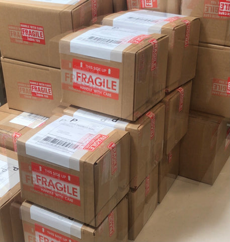 Blurred Shipping Boxes Stacked with Fragile Label