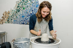 Ashley Norman throws pottery on the wheel in Winchester, KY