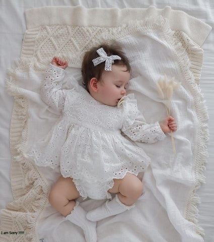 Newborn baby girl wearing one of her baby summer outfits.