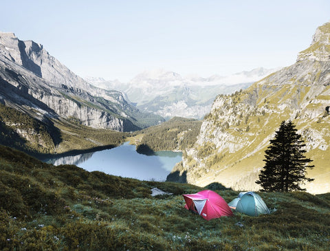 Tents on mountain overlooking lake