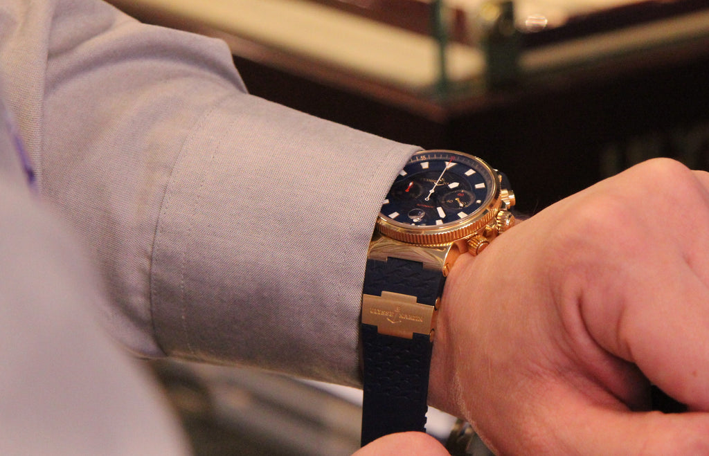 Man with shirt cuff putting Ulysse Nardin Watch on