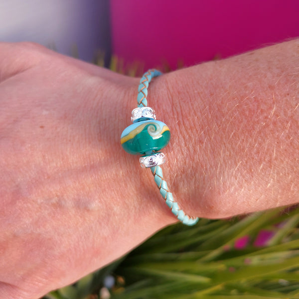 North Devon Biosphere bead on a turquoise leather carrier bracelet