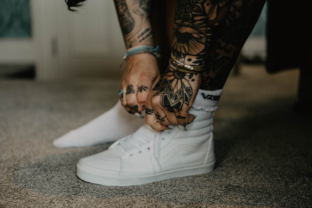 Bride tying up her trainers wearing Nalu Bead's wrap bracelet with silver charms