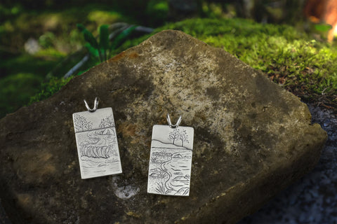 Two silver fundraiser pendants by Beth Millner Jewelry
