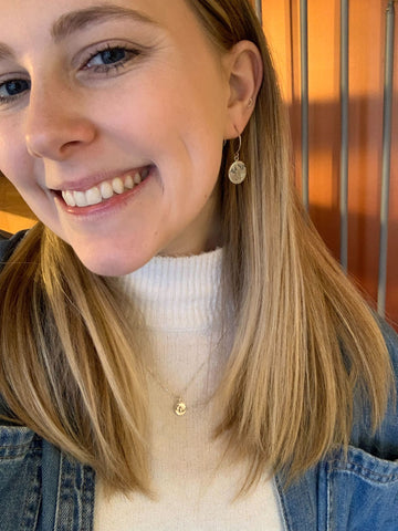 Randi wearing Beth Millner Jewelry's conifer couple lentil charm and eben ice caves earrings
