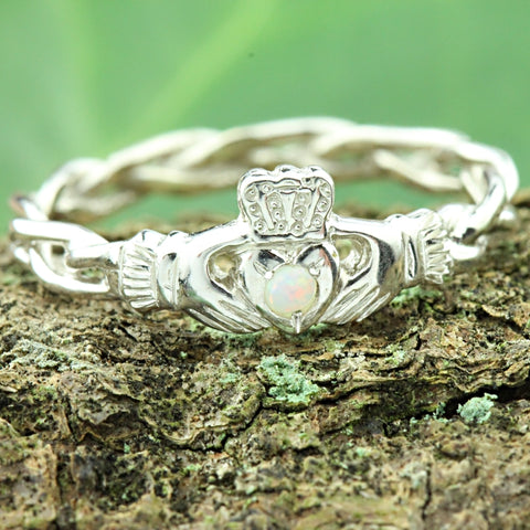 opal claddagh ring with a celtic twist rope band.